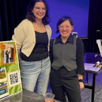 Liliana Bartels and Calla Lily pose together in front of sign